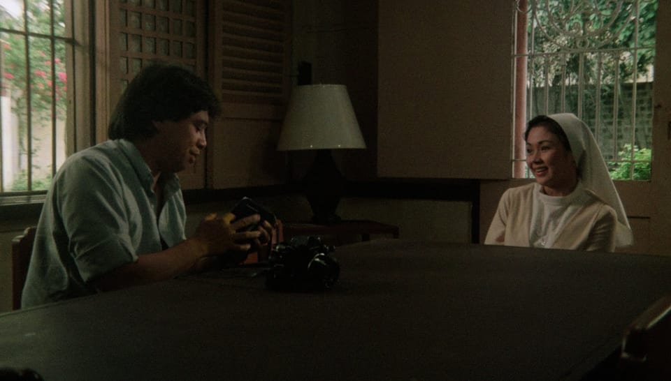 Jay Ilagan holds a camera and Vilma Santos in nun costume in Sister Stella L